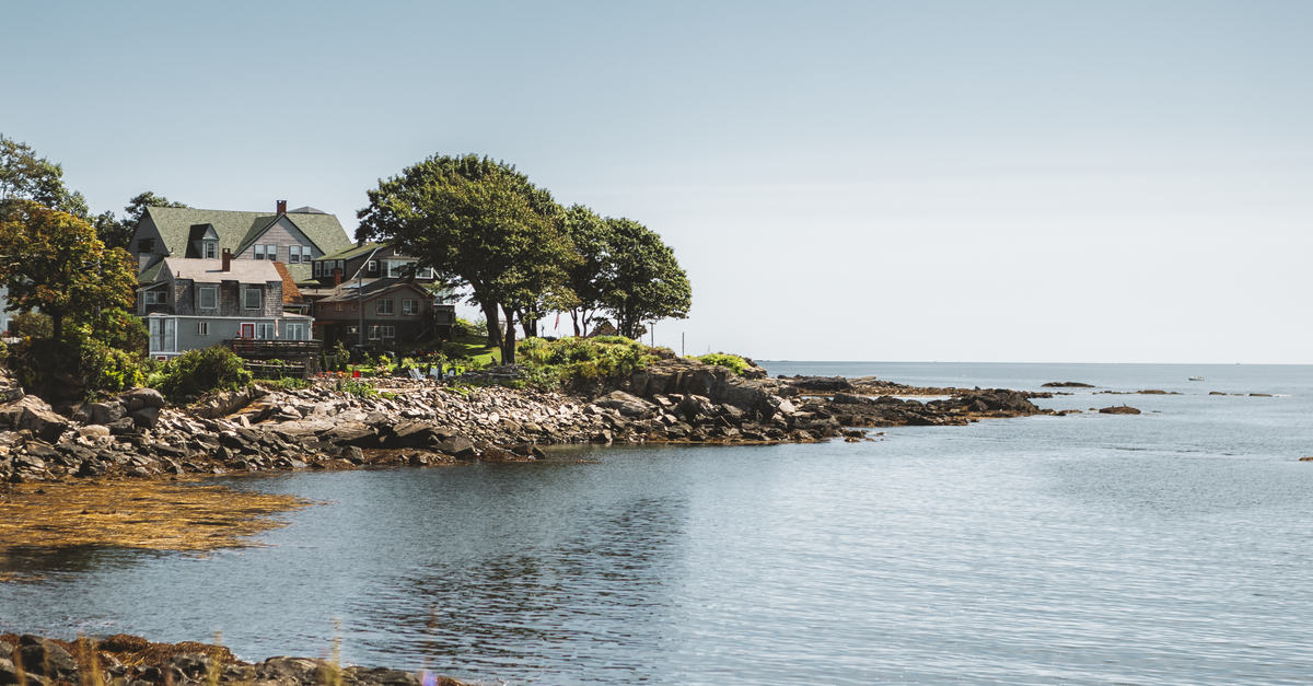 Charming coastal houses by rocky shore in Portland, Maine.